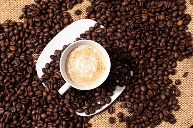 Vue de dessus de la tasse de café tardive et des grains torréfiés