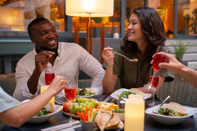 Photo vue de face amis profitant d'un dîner