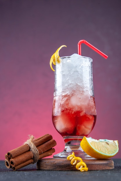 vue de face cocktail de fruits frais avec de la paille et de la glace sur fond rose foncé bar d'été jus de glace fête boisson couleur fraîche