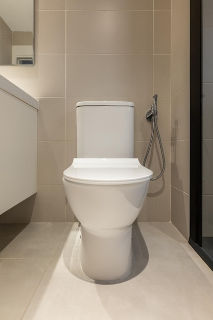 Vue de face d'une cuvette de toilette blanche dans un équipement sanitaire de salle de bain moderne pour une maison