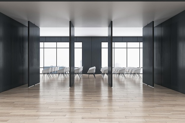 Vue de face sur une élégante cloison sombre sur un sol en bois clair et des rangées de chaises blanches dans un espace de conférence spacieux avec d'immenses fenêtres rendu 3D