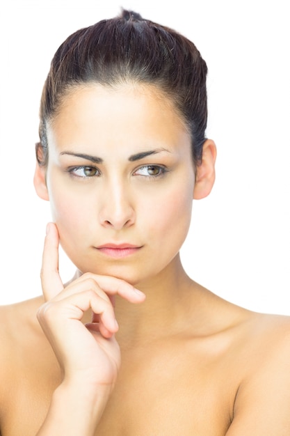 Vue de face de la femme brune concentrante en détournant les yeux