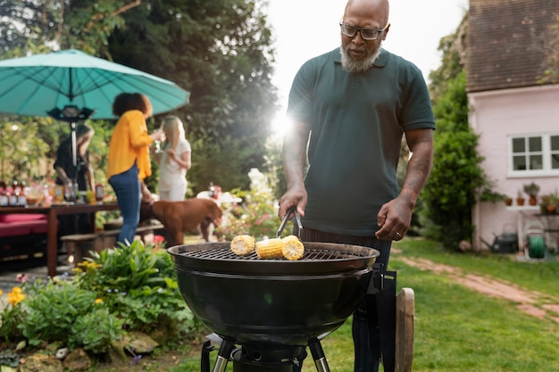 Photo vue de face homme faisant un barbecue