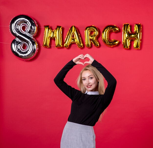 vue de face jeune femme avec décoration de mars sur fond rouge luxueux égalité féminine womans day salon passion sensuelle vacances