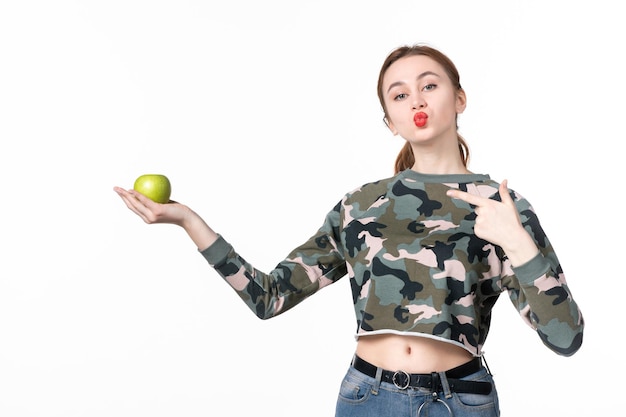 Vue de face jeune femme tenant pomme verte fond blanc régime horizontal bien-être soins de santé plat humain jus de fruits peau