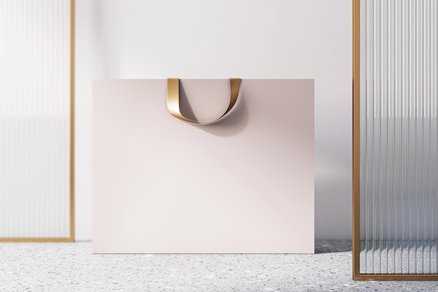 Vue de face sur un sac à provisions en papier beige vierge avec une tresse dorée et un espace pour votre nom de marque ou votre texte sur un sol en béton et un fond de mur clair en gros plan rendu 3D maquette