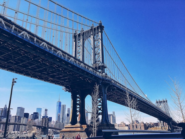 Vue à faible angle du pont de Manhattan dans la ville contre un ciel bleu clair