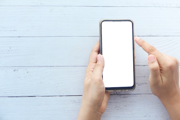Vue grand angle de la main des femmes à l'aide de téléphone intelligent avec espace de copie.