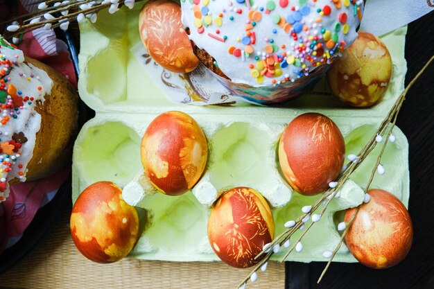 Vue en gros plan des œufs de poule, du gâteau de Pâques fait maison et des brindilles de saule