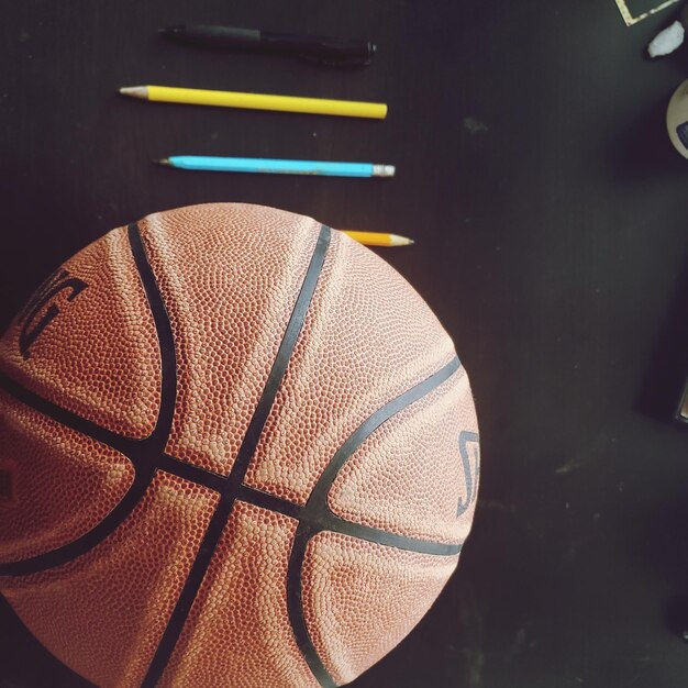 Photo vue à haut angle du basket-ball et des crayons de couleur sur la table