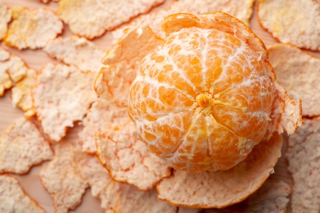 Vue de haut en bas de la mandarine pelée avec la peau autour Mandarine savoureuse mûre