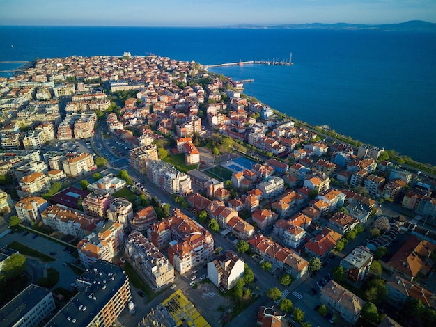 Vue d'une hauteur au-dessus de la ville de Pomorie avec des maisons et des rues baignées par la mer Noire en Bulgarie