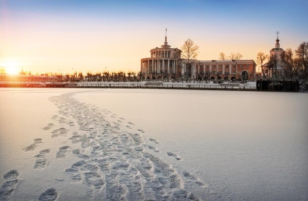 Vue hivernale exceptionnelle depuis la rivière gelée à une station fluviale et un temple à Tver