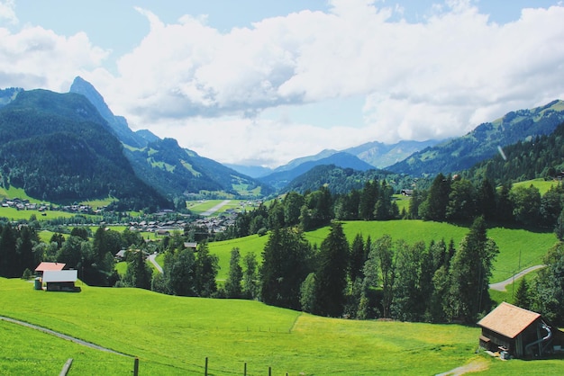 Vue idyllique des maisons sur les montagnes contre un ciel nuageux