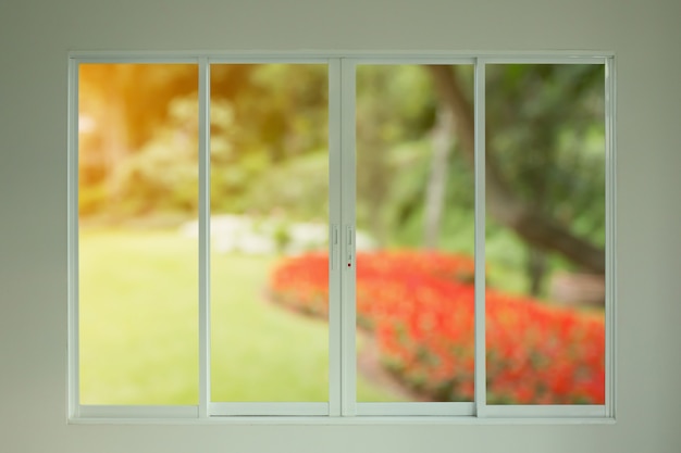 Vue sur le jardin vert à travers la fenêtre