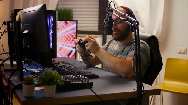 Photo vue latérale d'un streamer pro avec un casque jouant à des jeux vidéo en ligne avec un chat en streaming ouvert