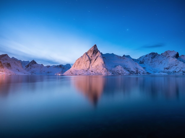 Vue sur les montagnes du village de Hamnoy Îles Lofoten Norvège Paysage en hiver pendant l'heure bleue Montagnes et eau Image de voyage