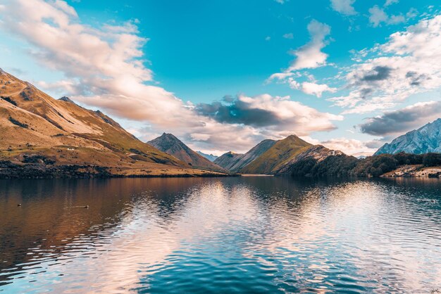 Vue panoramique du lac par les montagnes contre le ciel