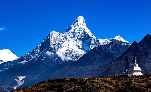 Photo vue panoramique des montagnes enneigées avec une sculpture symbolique népalaise