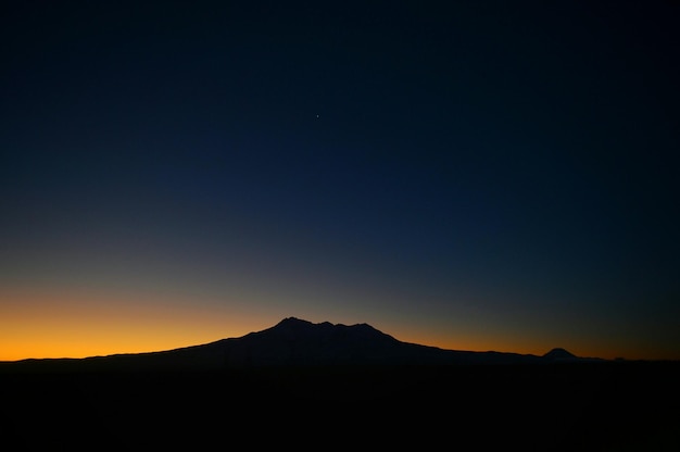 Vue panoramique de la silhouette de la montagne contre le ciel au coucher du soleil