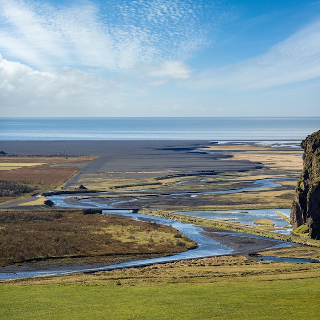 Vue pendant un voyage en voiture en Islande Spectaculaire paysage islandais avec une nature pittoresque océan côte fjords champs rivière route