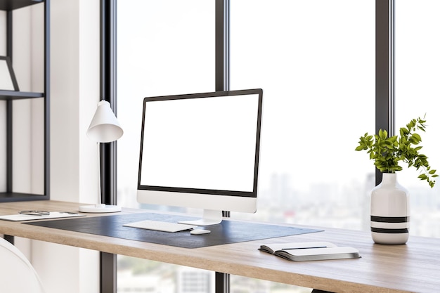 Vue en perspective sur un écran d'ordinateur moderne blanc vierge avec un espace pour votre logo ou votre texte sur une table en bois élégante sur fond de fenêtre panoramique avec vue sur la ville maquette de rendu 3D