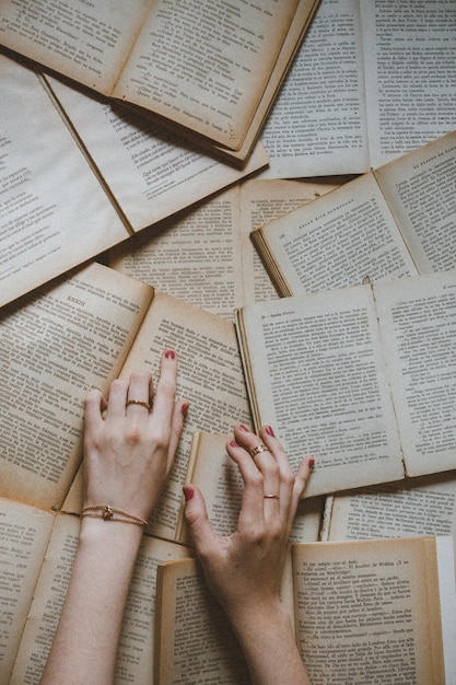 Vue en plongée de mains sur des livres