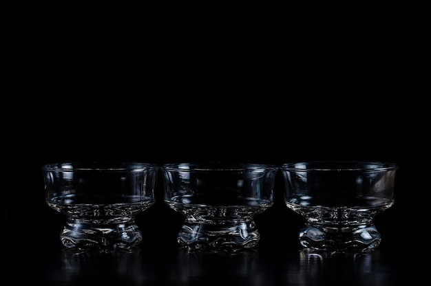 Photo vue rapprochée des bols de verre sur un fond noir