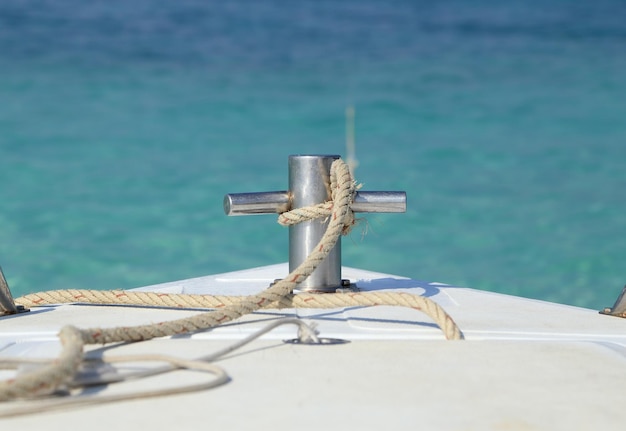 Photo vue rapprochée d'une corde attachée à un bollard contre la mer