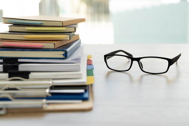 Photo vue rapprochée du bloc-notes et des lunettes sur la table