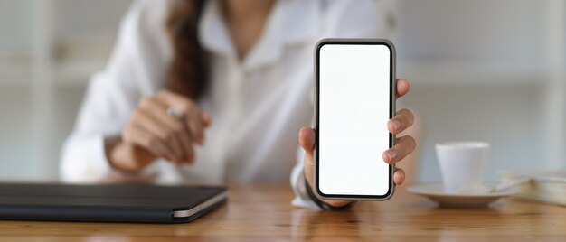 Vue Rapprochée De La Femme Montrant L'écran Du Smartphone Comprennent Un Tracé De Détourage