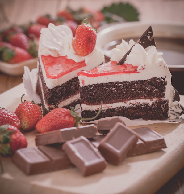 Vue rapprochée des gâteaux avec des chocolats et des fraises sur la table