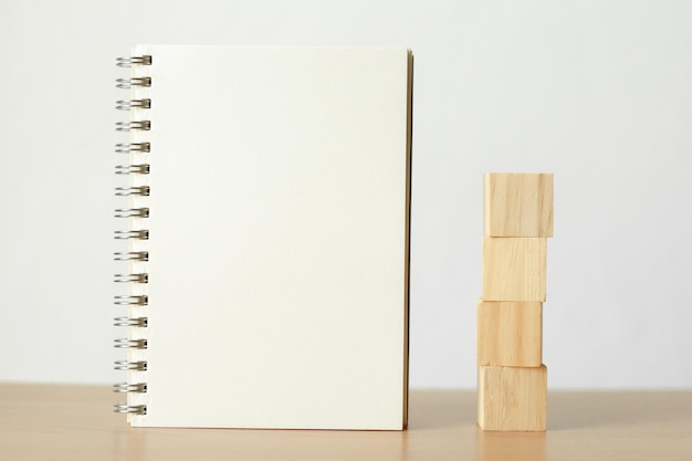 Vue rapprochée d'un livre avec des blocs de bois sur une table sur un fond blanc