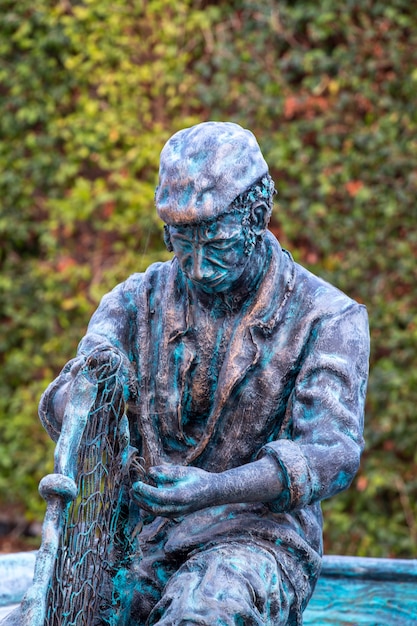 Photo vue rapprochée d'une statue de pêcheur en bronze, située dans la ville d'olhao, au portugal.