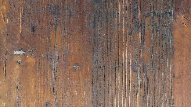 Une vue rapprochée d'une surface en bois texturée présentant des grains naturels et des variations de couleur