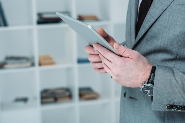 Vue recadrée d'un homme d'affaires utilisant une tablette numérique au bureau