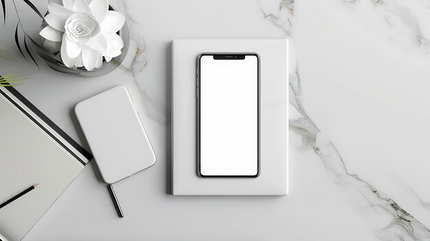 Vue supérieure d'une maquette de smartphone sur une table en marbre Le smartphone est placé sur un livre blanc