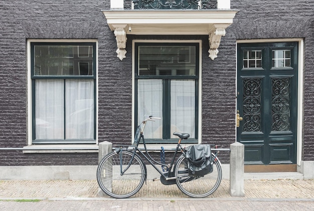 Vue typique de la rue d'Amsterdam aux Pays-Bas avec de vieilles portes et fenêtres et un vélo vintage