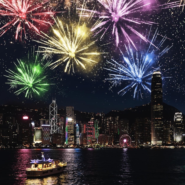 Vue de la ville moderne de nuit avec les feux d'artifice colorés Hong Kong du port de Victoria