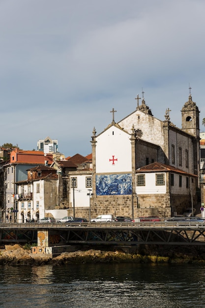 Photo vue sur la ville de porto au bord de la rivière ribeira et bateaux à vinrabelo sur le fleuve douroportugal ville classée au patrimoine mondial de l'unesco