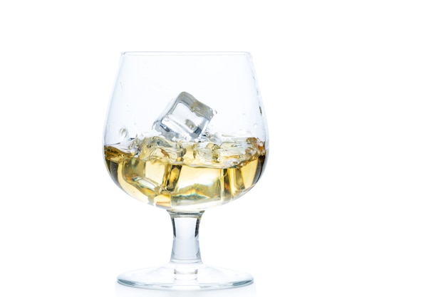 Whisky ou brandy avec de la glace dans un verre Snifter ou Balloon isolé sur fond blanc, concept de boisson