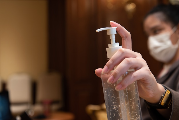 Woman holding pot de gel hygiénique