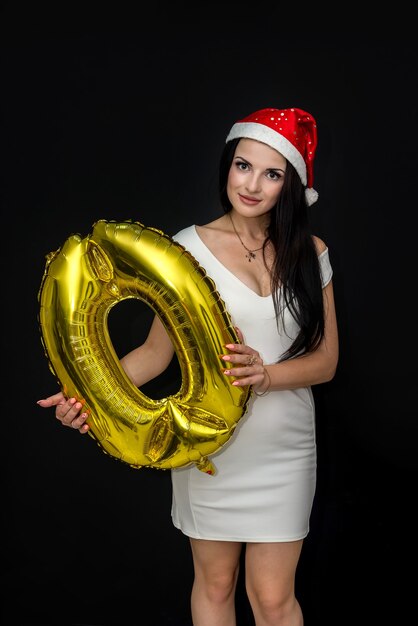 Woman in santa hat holding ballon à air 'zéro'