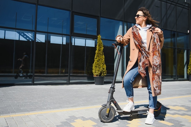 Woman riding un scooter électrique à l'extérieur