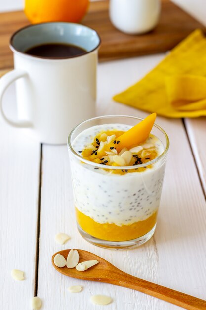 Yaourt dans un verre avec mangue, chia et amandes. Alimentation équilibrée. La nourriture végétarienne. Recette. Petit déjeuner. Régime.