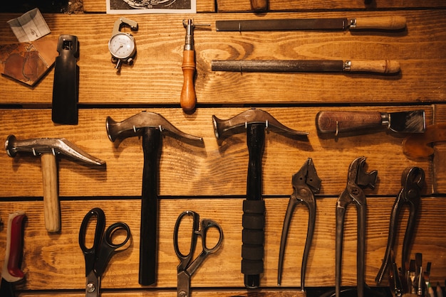 Ynstruments sur mur en bois à l'atelier de chaussures.