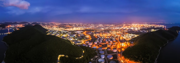 Zone de l&#39;industrie pétrolière de raffinerie pendant la nuit sur coloré et éclairage avec ciel bleu aérien