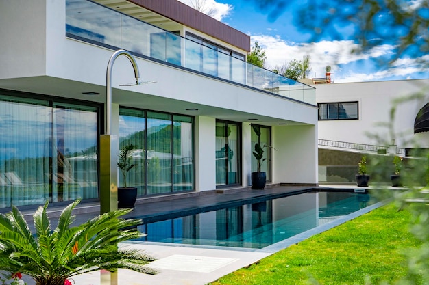 a house with a pool and a large house in the background