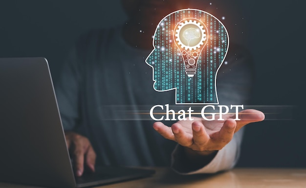 A man is holding a laptop and a head with the words Chat GPT on it