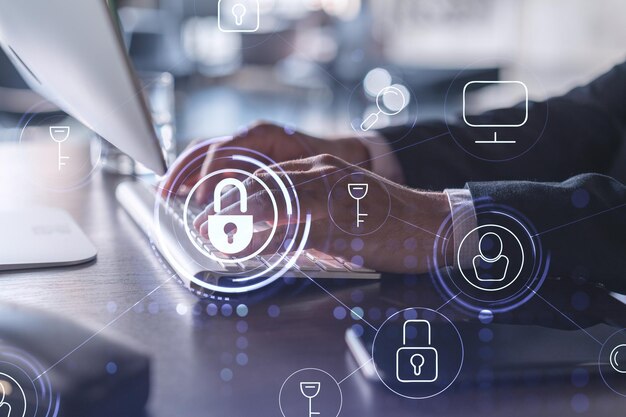 A programmer is typing a code on computer to protect a cyber security from hacker attacks and save clients confidential data Padlock Hologram icons over the typing hands Formal wear
